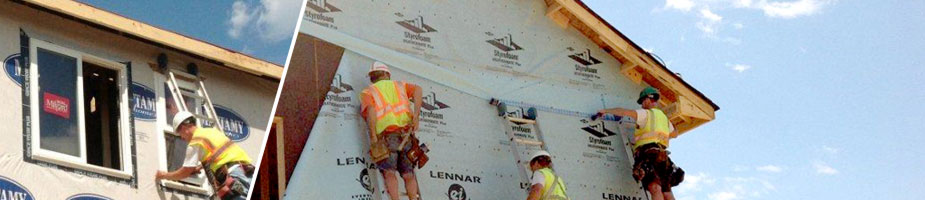 carpentry crew installing housewrap, windows and doors